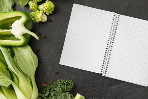 Green vegetables and diary with empty pages Foto stock