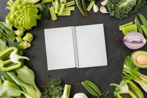 Green vegetables and diary with empty pages Stock Photos