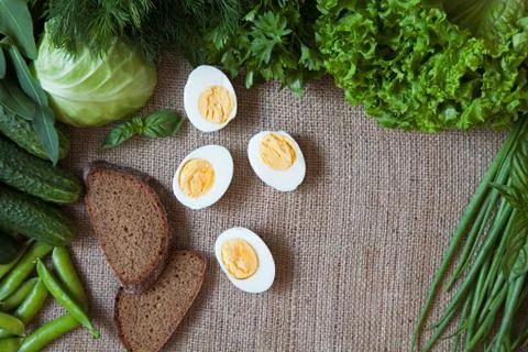 Green vegetables composition frame with wholewheal bread and eggs on rustic Stock Photos