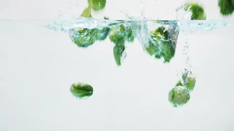 Green Vegetables Falling into Water 002 Stock Footage 67889555