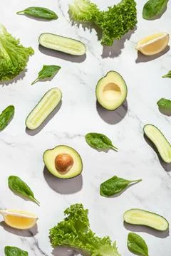 Green vegetables on a white table. Background with salad ingredients. Healthy Stock Photos
