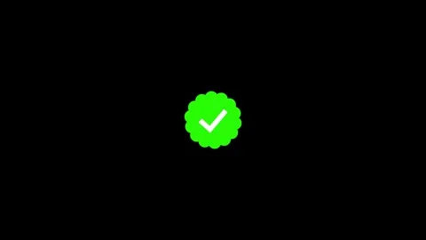 Green verified checkmark badge icon white tick mark scalloped frame dark bg. Stock Footage 346723091