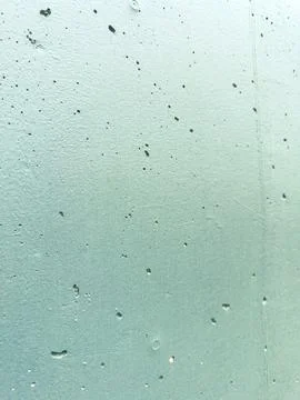 Green wall with rough texture showing small bumps and holes during daylight.. 库存照片