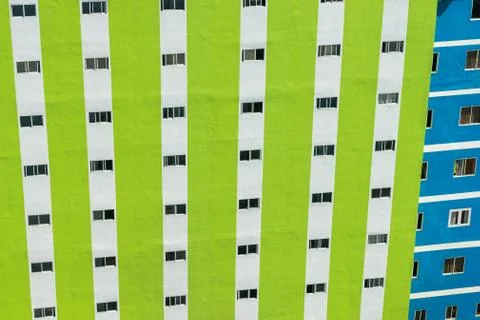 Green wall of skyscraper with row of windows Stock Photos