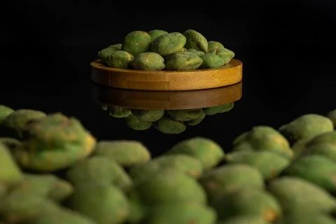 Green wasabi peanut isolated on black glass Stock Photos