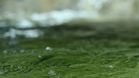 Green water with bubbles in a pool in the mountains (slow motion, bokeh) Stock-Footage 211761032