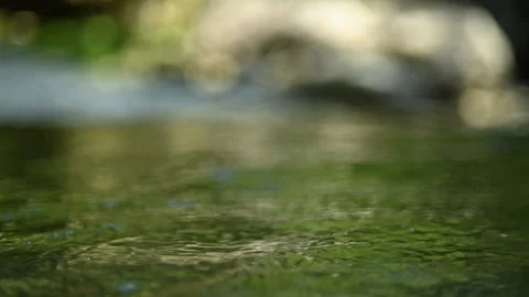 Green water in a natural pool of a mountain river (slow motion, bokeh) Stock Footage 211759601