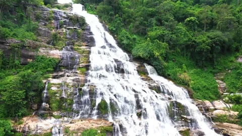 The Green-Waterfall-River-rocks-covered-with-green-moss-Forest-Waterfall  Stock Footage 199599808