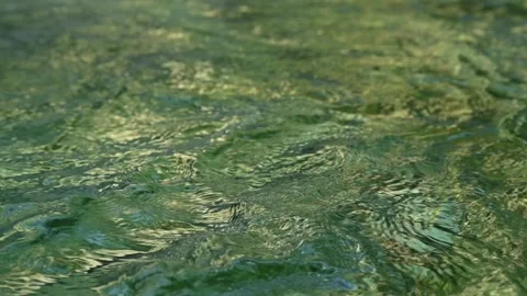 Green waves on the pond of a mountain stream (abstract, slow motion) 스톡 동영상 260844436