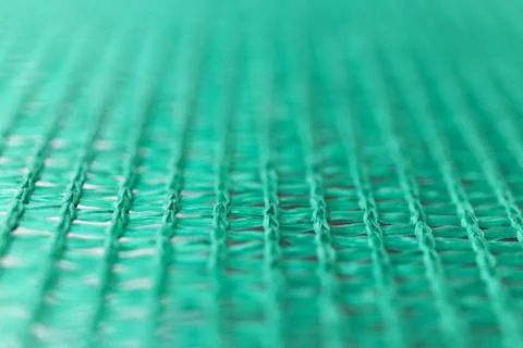 Green wired net surface with blurred background. Advertising backdrop. Stock Photos
