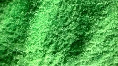 Green wool fabric texture creating wavy soft background. Stock Footage 316031597