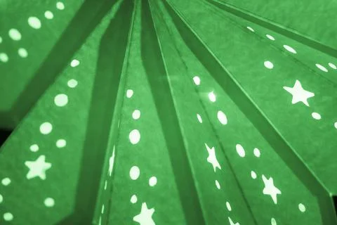 Green xmas lantern star pattern at christmas market season. Shiny star mood l Stock Photos