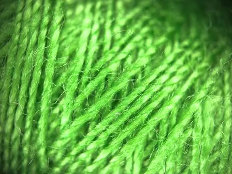 Green yarn thread texture close up macro concept for knitting, textile industry, Stock-Fotos