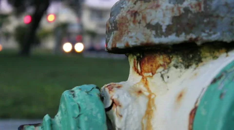 Green &amp; Yellow Rusty Fire Hydrant - Traffic In Background Stock Footage 594957