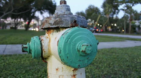 Green &amp; Yellow Rusty Fire Hydrant - Traffic In Background Stock Footage 595045