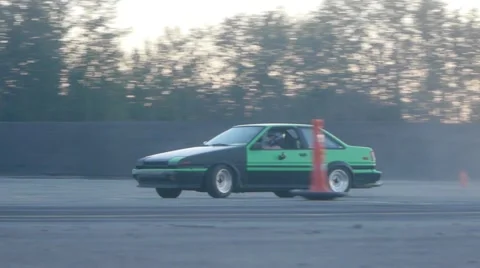 Green/Black car drifting around corner on drift racing track Stock Footage 59762093