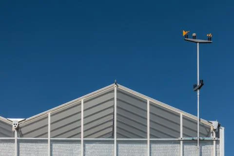 Greenhouse with an anemometer attached Stock Photos
