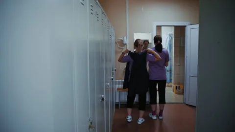 Greenhouse Workers Dressing in Locker Room 스톡 동영상 313527088