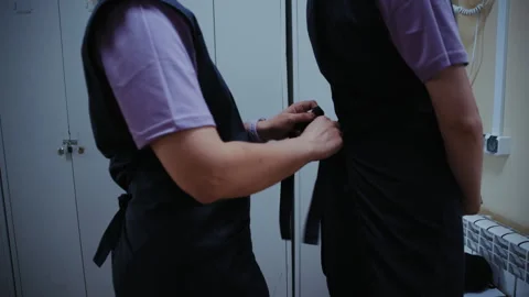 Greenhouse Workers Dressing for the Workday Stock Footage 313527075