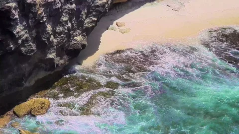 Greenish water waves hitting the rocks at Broken Bridge, Penida island, Bali Stock Footage 129882352