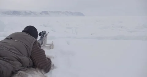 Greenland hunter tests scope and makes adjustment Stock Footage 138227017