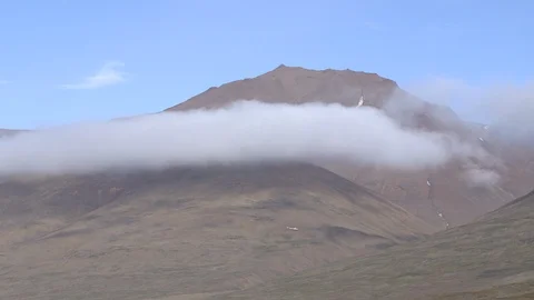 Greenlandic mountain surrounded by clouds Stock Footage 103357769