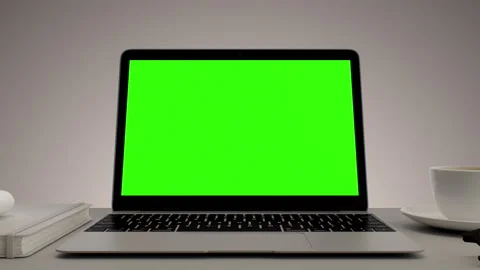 Greenscreen display on laptop set on white table. Home office workspace. Close Video stock 315073461