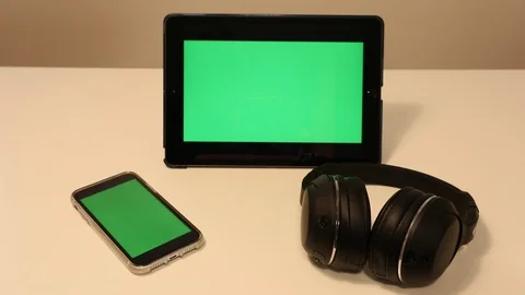 Greenscreen iPad and iPhone Wireless Head Phones Stock Footage 127264886