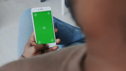 Greenscreen or Mock-up Tracking in African American Male Hands. Using Smartphone Stock Footage 120687787