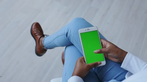 Greenscreen or Mock-up Tracking in African American Girl Hands. Using Smartphone Stock Footage 121087532