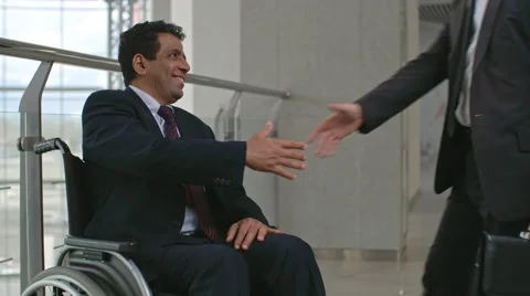 Greeting Business Partner in Wheelchair Stock Footage