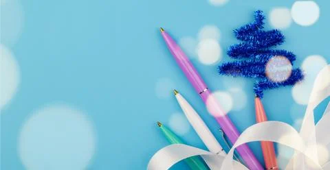 Greeting card with multi-colored pens and ribbon. Stock Photos