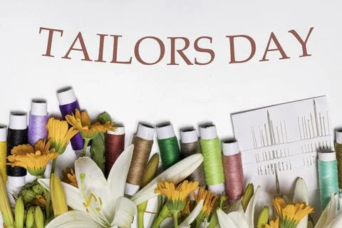 Greeting card with multi-colored threads and the text Tailors Day. For the Stock Photos