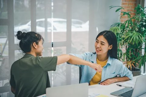 Greeting by elbowing instead of shaking hands, social distance.preventing c.. Stock Photos