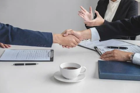 Greeting new colleagues, Handshake while job interviewing, male candidate sha Stock Photos