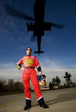 Greg Biffle Strikes a Pose as Army Apache Flies Over National Guard Photo Sho Stock Photos