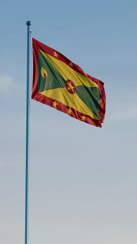 Grenada, St Georges: Cinematic Vertical Waving National Flag Against Blue Sky 스톡 동영상 321871078