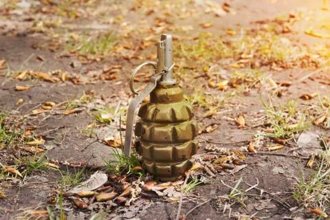 Grenade lying on the ground. Hand grenade F-1. abandoned lost pomegranate gre Stock Photos