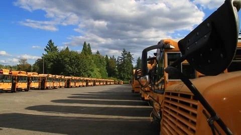 Gresham, Oregon, June 28, 2015 – A fleet of school buses are lined up in a Stock Footage 92225585