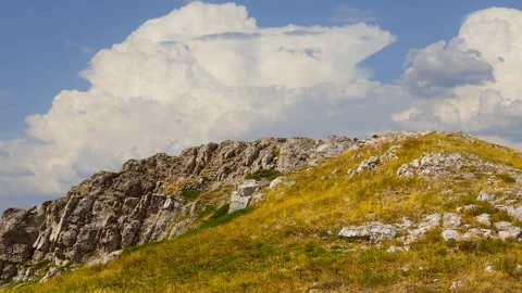 Gress mount slope under a dense cloudy sky Stock-Footage 319748878
