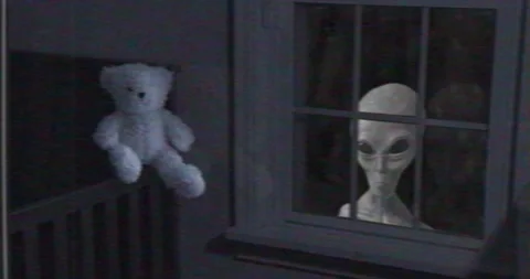 Grey Alien looking through a child’s bedroom window Stock Footage 155470431