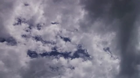 Grey and white clouds move across a gloomy sky Stock Footage 329755941