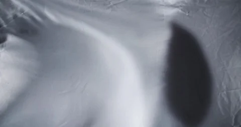 Grey and White silk satin sheet flag flowing in wind / slow motion Stock Footage 129639763