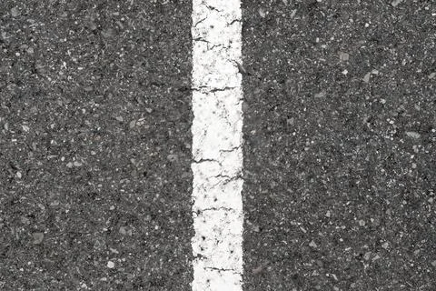 Grey asphalt road surface featuring a straight white painted traffic line  Stock Photos