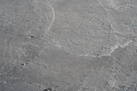 The grey background of drying hand-mixed concrete and limescale waves. Stock Photos