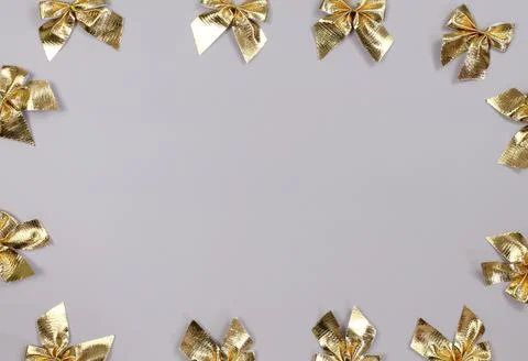 Grey background with gold bow frame Stock Photos