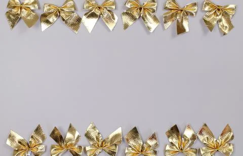 Grey background with gold bow frame Stock Photos