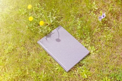 Grey book on the grass Stock Photos