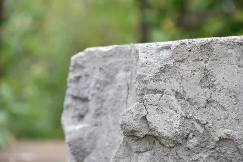 Grey brick on the green background. selective focus Stock Photos