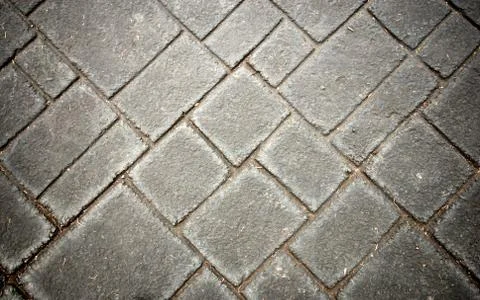 Grey brick in the ground Stock Photos